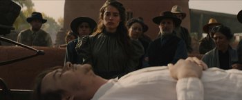 Movie still from “The Kid” (2019), directed by Vincent D'Onofrio – A group of people standing next to a dead body; Medium shot, Over the shoulder angle