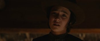 Movie still from “The Kid” (2019), directed by Vincent D'Onofrio – A young boy wearing a cowboy hat looking at the camera; Close Up shot, Low angle