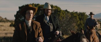 Movie still from “The Kid” (2019), directed by Vincent D'Onofrio – A man and a woman riding on a horse; Medium shot, Over the shoulder angle