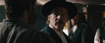 Movie still from “The Kid” (2019), directed by Vincent D'Onofrio – A person wearing a hat; Close Up shot, Over the shoulder angle