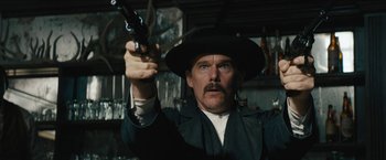 Movie still from “The Kid” (2019), directed by Vincent D'Onofrio – A man holding a gun up to the air; Close Up shot, Low angle