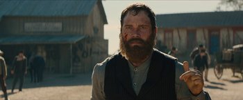 Movie still from “The Kid” (2019), directed by Vincent D'Onofrio – A man with a long beard and a mustache is standing outside; Close Up shot, Low angle