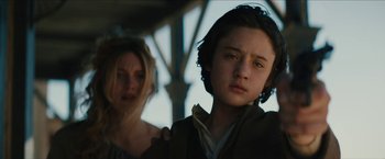 Movie still from “The Kid” (2019), directed by Vincent D'Onofrio – Two people standing next to each other on a bridge; Close Up shot, Low angle