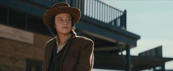 Movie still from “The Kid” (2019), directed by Vincent D'Onofrio – A person wearing a hat and a jacket; Medium shot, Low angle