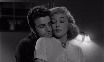 Movie still from “The Killing” (1956), directed by Stanley Kubrick – A man and a woman embracing each other in black and white; Close Up shot, Low angle