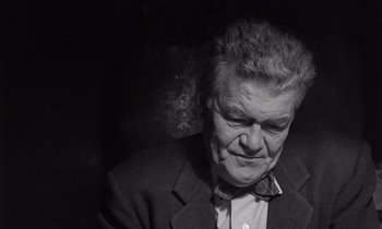 Movie still from “The Killing” (1956), directed by Stanley Kubrick – An older man wearing a suit and bow tie; Close Up shot, Low angle