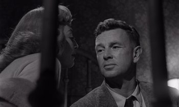 Movie still from “The Killing” (1956), directed by Stanley Kubrick – A man and a woman are looking at each other; Close Up shot, Low angle