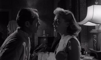 Movie still from “The Killing” (1956), directed by Stanley Kubrick – A man and a woman are looking at one another; Close Up shot, Low angle