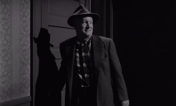 Movie still from “The Killing” (1956), directed by Stanley Kubrick – An older man wearing a suit and hat; Medium shot, Low angle