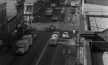 Movie still from “The Killing” (1956), directed by Stanley Kubrick – An aerial view of an intersection with cars and pedestrians; Extreme Wide shot, High angle