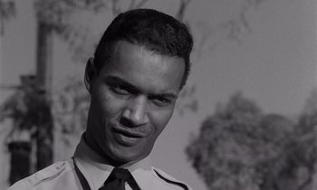 Movie still from “The Killing” (1956), directed by Stanley Kubrick – A black and white photo of a man in a tie; Close Up shot, Low angle