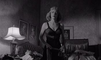 Movie still from “The Killing” (1956), directed by Stanley Kubrick – A black and white photo of a woman in a bedroom; Medium shot, Low angle