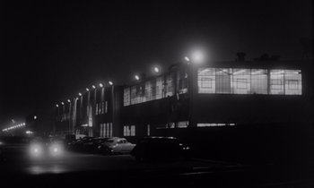 Movie still from “The Killing” (1956), directed by Stanley Kubrick – A black and white photo of a parking lot at night; Extreme Wide shot, Low angle
