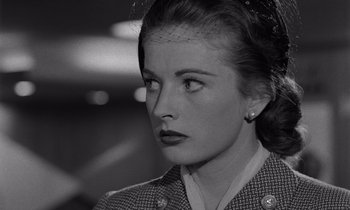 Movie still from “The Killing” (1956), directed by Stanley Kubrick – A woman in a military uniform looking to her left; Close Up shot, Low angle