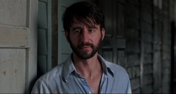 Movie still from “The Killing Fields” (1984), directed by Roland Joffé – A person wearing a shirt; Close Up shot, Low angle