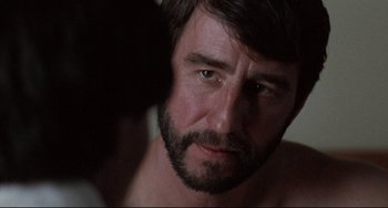 Movie still from “The Killing Fields” (1984), directed by Roland Joffé – A person with a beard; Close Up shot, Over the shoulder angle