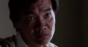 Movie still from “The Killing Fields” (1984), directed by Roland Joffé – A man's eyes and face; Extreme Close Up shot, Low angle
