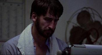 Movie still from “The Killing Fields” (1984), directed by Roland Joffé – A man with a towel around his neck looking at a mirror; Close Up shot, Low angle