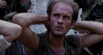 Movie still from “The Killing Fields” (1984), directed by Roland Joffé – A person with his hands behind his head; Close Up shot, Low angle