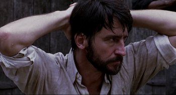 Movie still from “The Killing Fields” (1984), directed by Roland Joffé – A person holding his hands in his hair; Close Up shot, Low angle