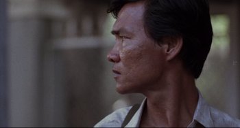 Movie still from “The Killing Fields” (1984), directed by Roland Joffé – A person looking to his left; Close Up shot, Over the shoulder angle