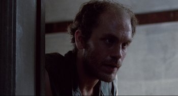 Movie still from “The Killing Fields” (1984), directed by Roland Joffé – A person with a beard; Close Up shot, Low angle