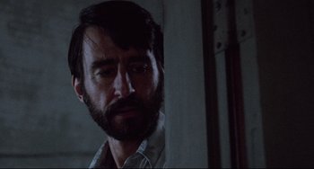 Movie still from “The Killing Fields” (1984), directed by Roland Joffé – A man with a goatee and a beard looking to his left; Close Up shot, Low angle
