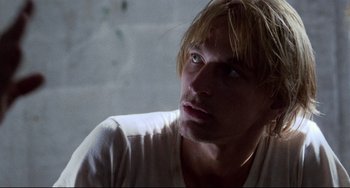 Movie still from “The Killing Fields” (1984), directed by Roland Joffé – A person with long blonde hair; Close Up shot, Low angle