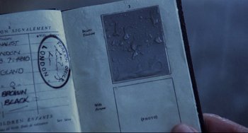 A person holding an open book with a stamp on it