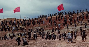 Movie still from “The Killing Fields” (1984), directed by Roland Joffé – A group of people standing on top of a hill; Extreme Wide shot, High angle