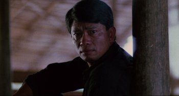 Movie still from “The Killing Fields” (1984), directed by Roland Joffé – A person wearing a black shirt; Close Up shot, Low angle