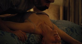 Movie still from “The Killing of a Sacred Deer” (2017), directed by Yorgos Lanthimos – A woman laying on top of a bed with a man standing next to her; Close Up shot, Overhead angle