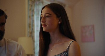 Movie still from “The Killing of a Sacred Deer” (2017), directed by Yorgos Lanthimos – A young woman with long brown hair looking to her left; Close Up shot, Over the shoulder angle