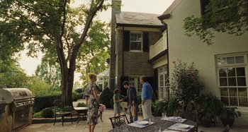 Movie still from “The Killing of a Sacred Deer” (2017), directed by Yorgos Lanthimos – A group of people standing outside of a brick house; Wide shot, Over the shoulder angle
