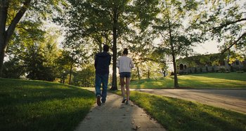 Movie still from “The Killing of a Sacred Deer” (2017), directed by Yorgos Lanthimos – A man and a woman walking down a sidewalk; Wide shot, Low angle
