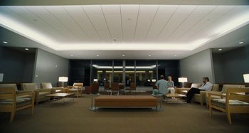 Movie still from “The Killing of a Sacred Deer” (2017), directed by Yorgos Lanthimos – People are sitting in a waiting area of an airport; Extreme Wide shot, High angle