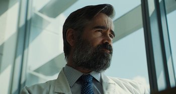 Movie still from “The Killing of a Sacred Deer” (2017), directed by Yorgos Lanthimos – A man in a white lab coat and a blue tie; Close Up shot, Low angle