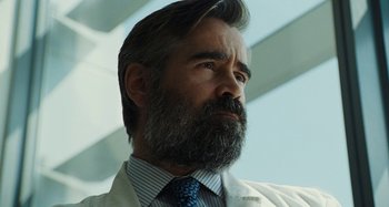 Movie still from “The Killing of a Sacred Deer” (2017), directed by Yorgos Lanthimos – A man with a gray beard wearing a white lab coat; Close Up shot, Low angle