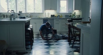 Movie still from “The Killing of a Sacred Deer” (2017), directed by Yorgos Lanthimos – A man and a boy are in a kitchen; Wide shot, High angle