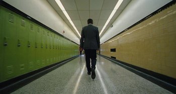 Movie still from “The Killing of a Sacred Deer” (2017), directed by Yorgos Lanthimos – A man in a suit walking down a hallway; Wide shot, High angle