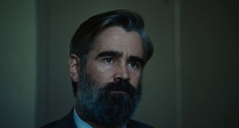 Movie still from “The Killing of a Sacred Deer” (2017), directed by Yorgos Lanthimos – A person wearing a suit and beard; Close Up shot, Over the shoulder angle