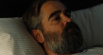 Movie still from “The Killing of a Sacred Deer” (2017), directed by Yorgos Lanthimos – A person with a beard laying in a bed; Close Up shot, High angle