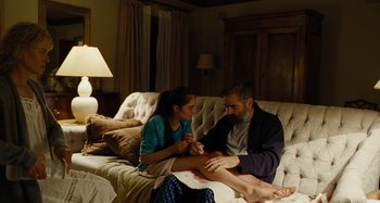Movie still from “The Killing of a Sacred Deer” (2017), directed by Yorgos Lanthimos – A man and a woman sitting on a white couch; Medium shot, High angle