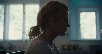 Movie still from “The Killing of a Sacred Deer” (2017), directed by Yorgos Lanthimos – A person wearing a white t - shirt; Close Up shot, Over the shoulder angle