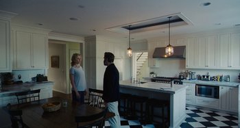 Movie still from “The Killing of a Sacred Deer” (2017), directed by Yorgos Lanthimos – A man and a woman standing in a kitchen next to each other; Wide shot, Low angle