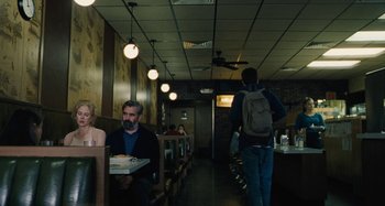 Movie still from “The Killing of a Sacred Deer” (2017), directed by Yorgos Lanthimos – A man and a woman sitting at a table in a restaurant; Wide shot, Over the shoulder angle