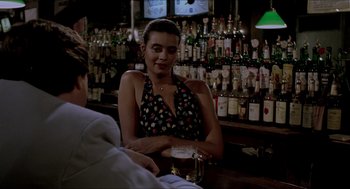 Movie still from “The King of Comedy” (1982), directed by Martin Scorsese – A woman sitting at a bar holding a glass of beer; Medium shot, Over the shoulder angle