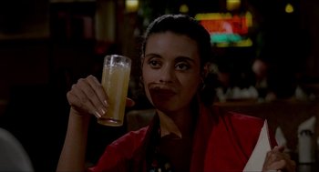 Movie still from “The King of Comedy” (1982), directed by Martin Scorsese – A woman is holding a glass of beer in her right hand; Close Up shot, Low angle