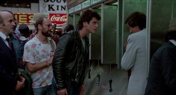 Movie still from “The King of Comedy” (1982), directed by Martin Scorsese – A group of men standing next to each other on a sidewalk; Medium shot, Over the shoulder angle