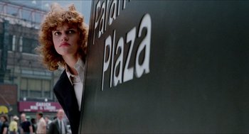 Movie still from “The King of Comedy” (1982), directed by Martin Scorsese – A woman standing in front of a sign that reads " patan plaza "; Medium shot, Low angle